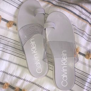 Size 10 Calvin Klein slide in sandals. Light grey with white soles. BRAND NEW!